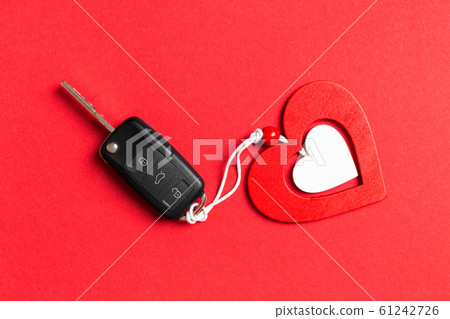Top view of car key, gift boxes and toy heart on 61242726