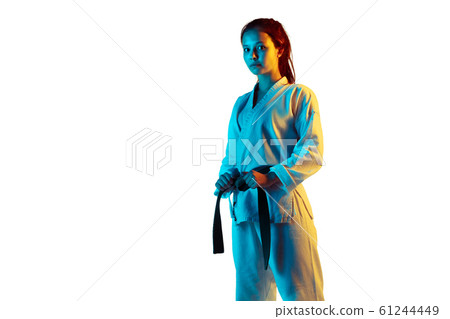 Confident junior in kimono practicing hand-to-hand combat, martial arts Confident junior in kimono practicing hand-to-hand combat, martial arts 61244449