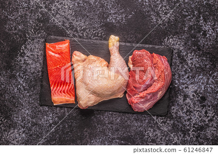 Meat, fish, chicken on the board. 61246847