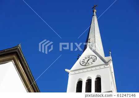 bell tower of a church with blue sky background bell tower of a church with blue sky background 61247146