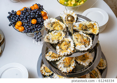 Fresh open oyster on a white plate. in the restaurant appetizer 61248334