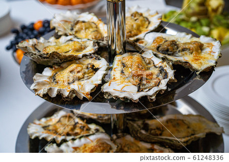 Fresh open oyster on a white plate. in the restaurant appetizer Fresh open oyster on a white plate. in the restaurant appetizer 61248336