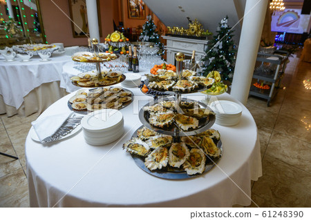 Fresh open oyster on a white plate. in the restaurant appetizer 61248390
