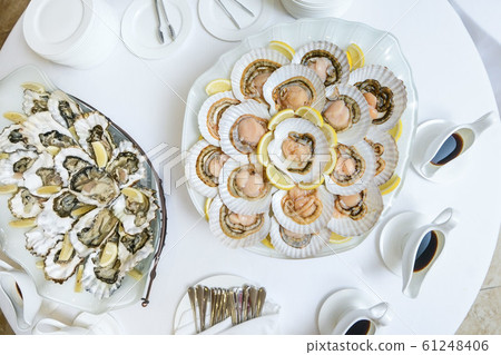 Scallops in the shell, cooked with chili. Delicious. Scallops in the shell, cooked with chili. Delicious. 61248406