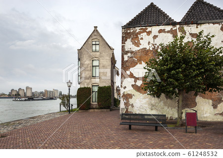 Buildings and a bench near river de Oude Maas in 61248532