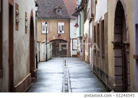 Wet narrow street in Wissembourg in France Wet narrow street in Wissembourg in France 61248545