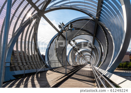 Modern metal footbridge over Manzanares River in Madrid 61249224