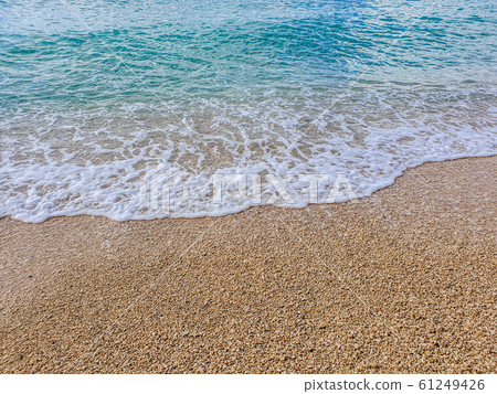 Pebble beach and wave foam 61249426