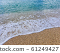 Pebble beach and wave foam 61249427
