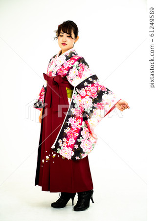 A woman with a small kimono and a hakama A woman with a small kimono and a hakama 61249589