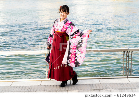 A woman with a small kimono and a hakama A woman with a small kimono and a hakama 61249634