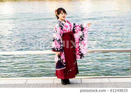A woman with a small kimono and a hakama 61249635