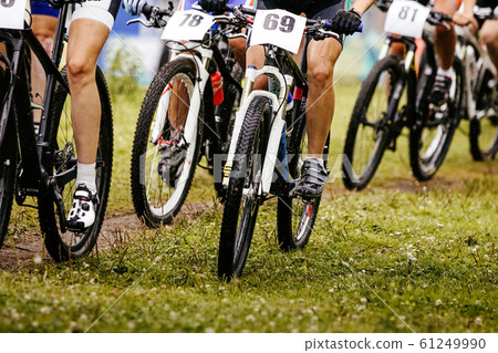 legs and wheels of bicycle riders cyclists 61249990