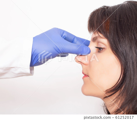 Doctor plastic surgeon prepares a caucasian girl for nose plastic surgery. Rhinoplasty Doctor plastic surgeon prepares a caucasian girl for nose plastic surgery. Rhinoplasty 61252017