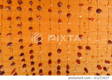 Dried persimmon suspended on a rope, air-drying dried fruits. 61253027