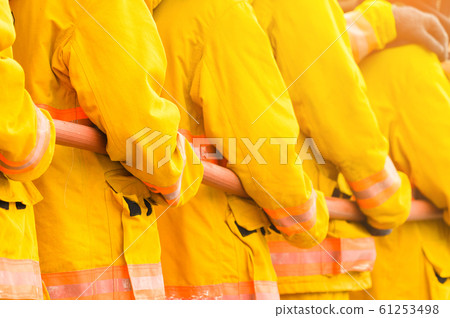 fireman fighting fire flame with water and extinguisher in training workshop 61253498