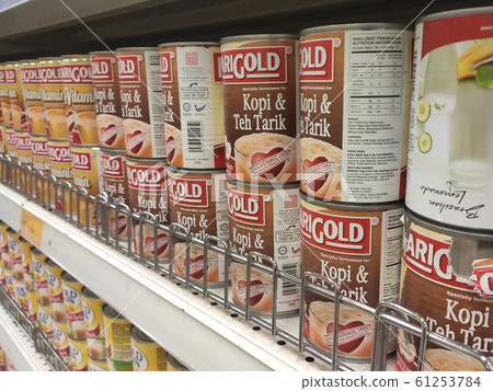 Sweetened creamer and evaporated milk packed in cans and displayed for sale on the rack inside the supermarket. The main ingredient is made from palm oil seeds. Sweetened creamer and evaporated milk packed in cans and displayed for sale on the rack inside the supermarket. The main ingredient is made from palm oil seeds. 61253784