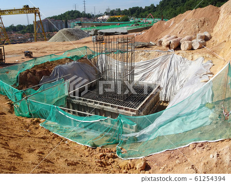 Pile cap and column stump under construction at the construction site. Constructed using reinforced concrete with plywood timber as a form work. 61254394