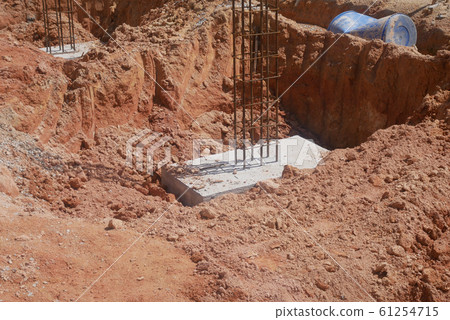 Casted pile cap at the construction site. It is part of the building foundation system. Protruded rebar is for the next stage of work. 61254715