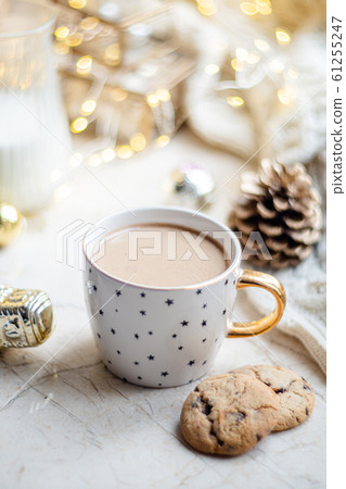 Cozy winter holiday decoration, Christmas lights and coffee cup with decor details, real home Cozy winter holiday decoration, Christmas lights and coffee cup with decor details, real home 61255247