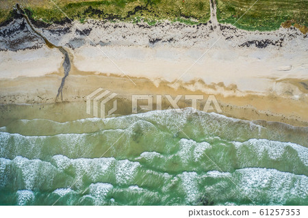 Aerial view of sandy beach and ocean with waves 61257353
