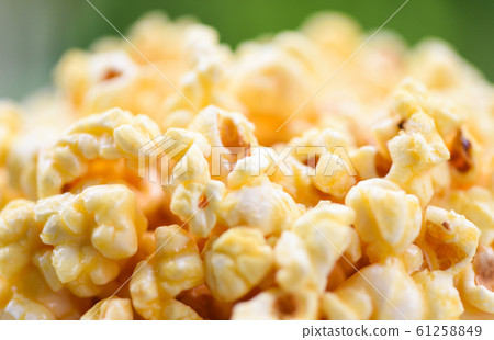 Close up popcorn in cup and nature green Close up popcorn in cup and nature green 61258849