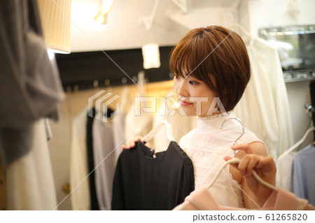 A woman choosing clothes A woman choosing clothes 61265820