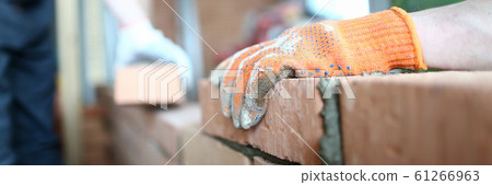 Skilled builder with bricks 61266963