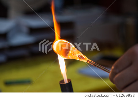 Artist works on glass with fire Artist works on glass with fire 61269958