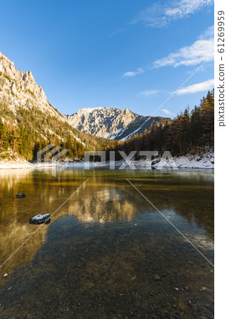 Peaceful mountain panorama view with famous green lake in Austria Styria. Tourist destination lake Gruner See in winter. 61269959