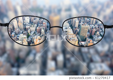 Clear cityscape focused in glasses lenses Clear cityscape focused in glasses lenses 61270417