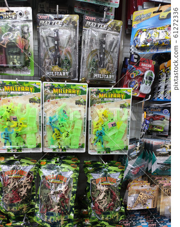 Children's toys & action figures are hung inside plastic packaging and exhibited to customers. Sorted by type and labelled with a price. Children's toys & action figures are hung inside plastic packaging and exhibited to customers. Sorted by type and labelled with a price. 61272336
