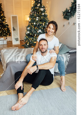 Romantic couple in love feeling happiness about their romance spending christmas eve together, Romantic couple in love feeling happiness about their romance spending christmas eve together, 61272384