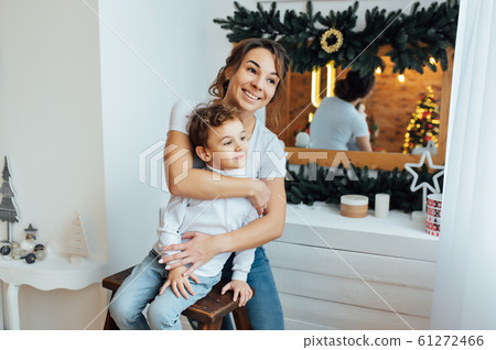 beautiful mother hugs her son on the couch beautiful mother hugs her son on the couch 61272466