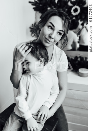 beautiful mother hugs her son on the couch 61272468