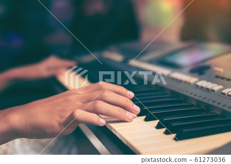 Playing the piano keyboard close up ,Cropped hands 61273036