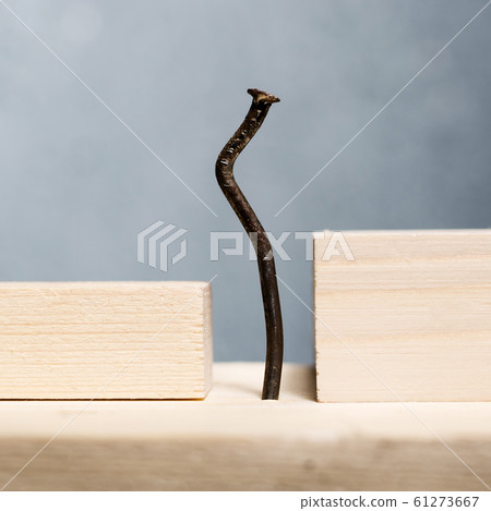 Wooden blocks and bent nail. Office worker 61273667