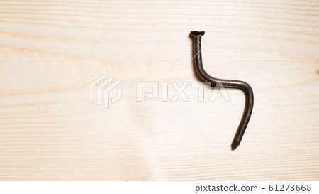 bent nail on a wooden board. Concept stoop, 61273668