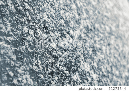 Snowflakes on a car glass close-up. Snowflakes on a car glass close-up. 61273844