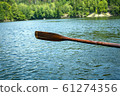 boat oar in the water and splashing water 61274356