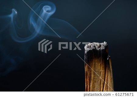 Palo Santo, holy sacred tree stick, macro close-up, burning with aromatic smoke. 61275671