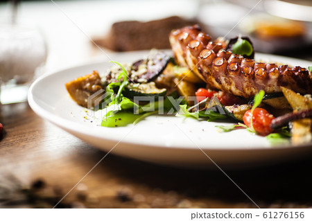 Octopus salad served on a plate in restaurant Octopus salad served on a plate in restaurant 61276156