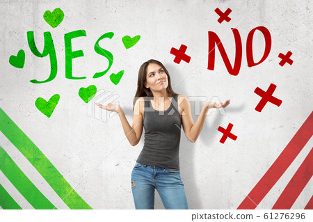 Young woman in casual clothes showing doubt with 'Yes' and 'No' sings on white background Young woman in casual clothes showing doubt with 'Yes' and 'No' sings on white background 61276296