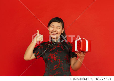 Happy Chinese new year. Asian young girls's portrait isolated on red background Happy Chinese new year. Asian young girls's portrait isolated on red background 61276893