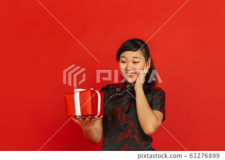 Happy Chinese new year. Asian young girls's portrait isolated on red background Happy Chinese new year. Asian young girls's portrait isolated on red background 61276899