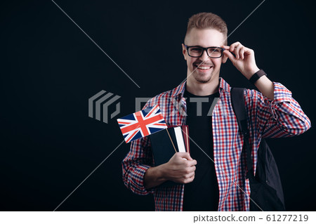 Cheerful English Male Student Adjusting Glasses Isolated Cheerful English Male Student Adjusting Glasses Isolated 61277219
