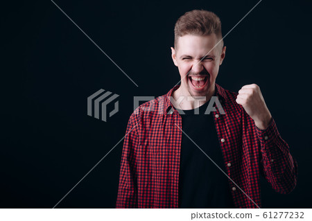 Young Lad Showing Success Emotions, Fist Clenched Young Lad Showing Success Emotions, Fist Clenched 61277232