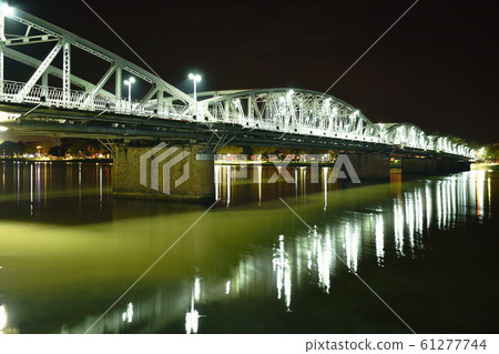 bridge cross river and reflection light bulb on night in Vietnam bridge cross river and reflection light bulb on night in Vietnam 61277744