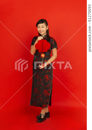 Happy Chinese new year. Asian young girls's portrait isolated on red background Happy Chinese new year. Asian young girls's portrait isolated on red background 61278093