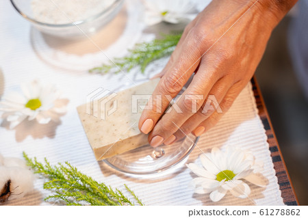 Female hand taking a cosmetic soap from the table 61278862
